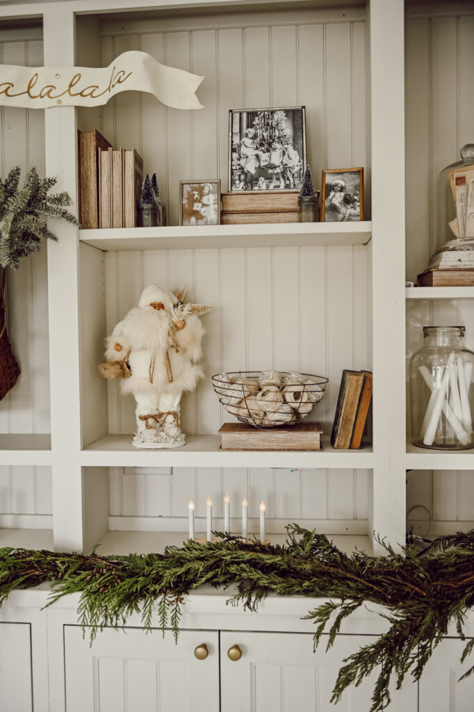 Cozy shelving styled with simple seasonal decor, soft textures, and vintage accents for a calm and clutter-free winter home.